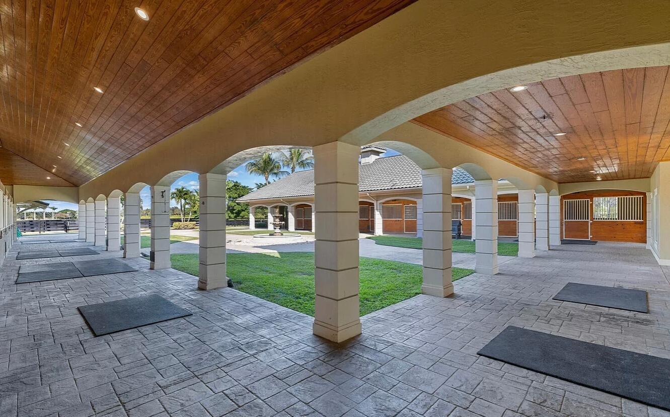 4591 S Road Wellington, FL 33414 - Photo 16 of 42 a front view of a house with a yard