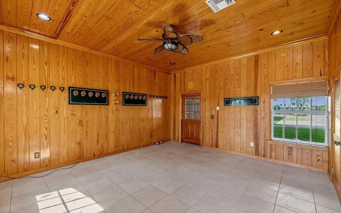 4591 S Road Wellington, FL 33414 - Photo 17 of 42 a view of a hallway with a chandelier