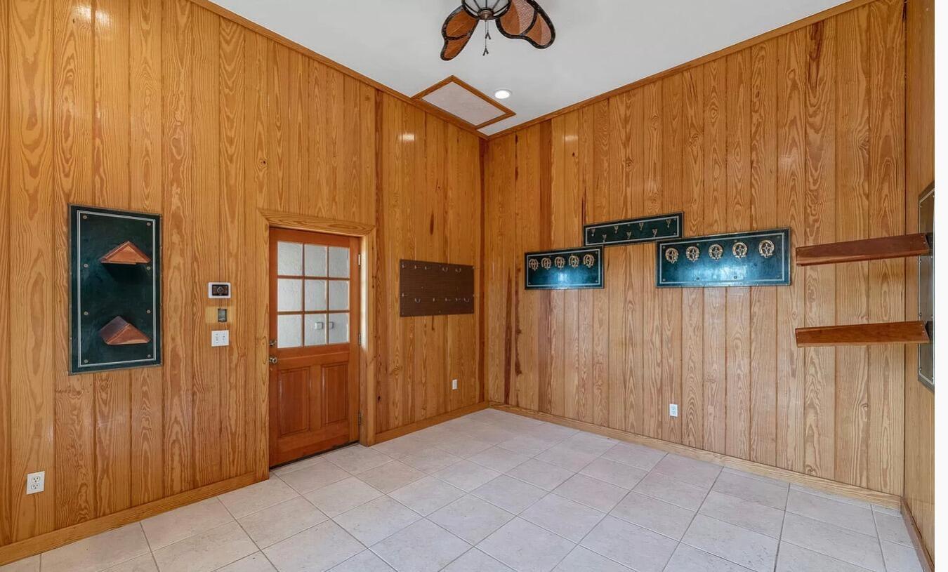 4591 S Road Wellington, FL 33414 - Photo 18 of 42 an empty room with windows cabinet and front door