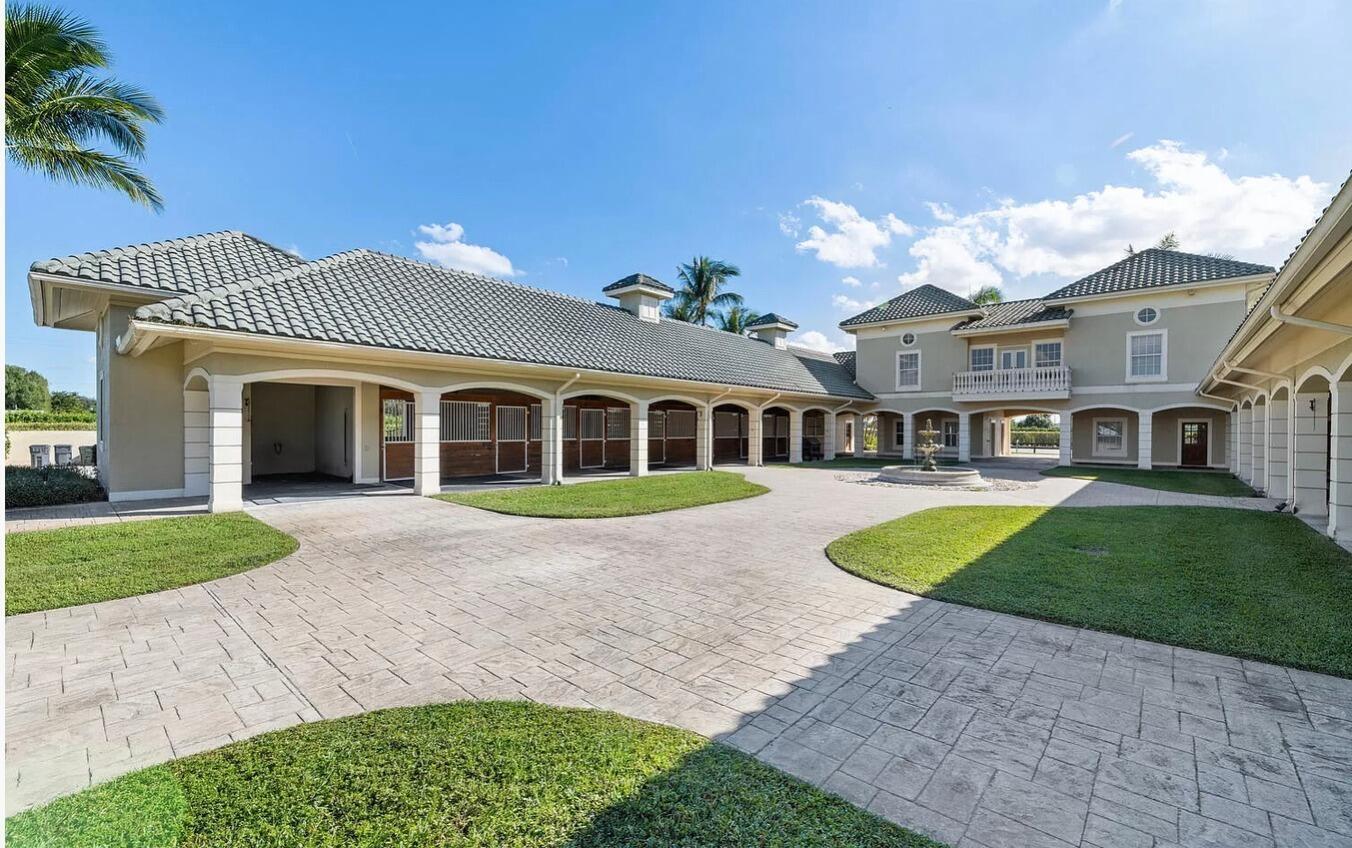 4591 S Road Wellington, FL 33414 - Photo 21 of 42 a front view of a house with a yard