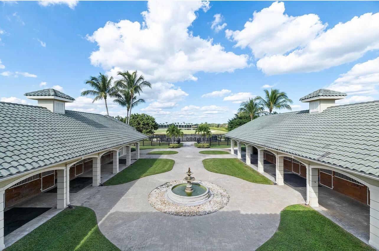 4591 S Road Wellington, FL 33414 - Photo 23 of 42 a balcony with table and chairs