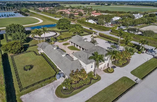 an aerial view of a house with yard swimming pool and outdoor seating
