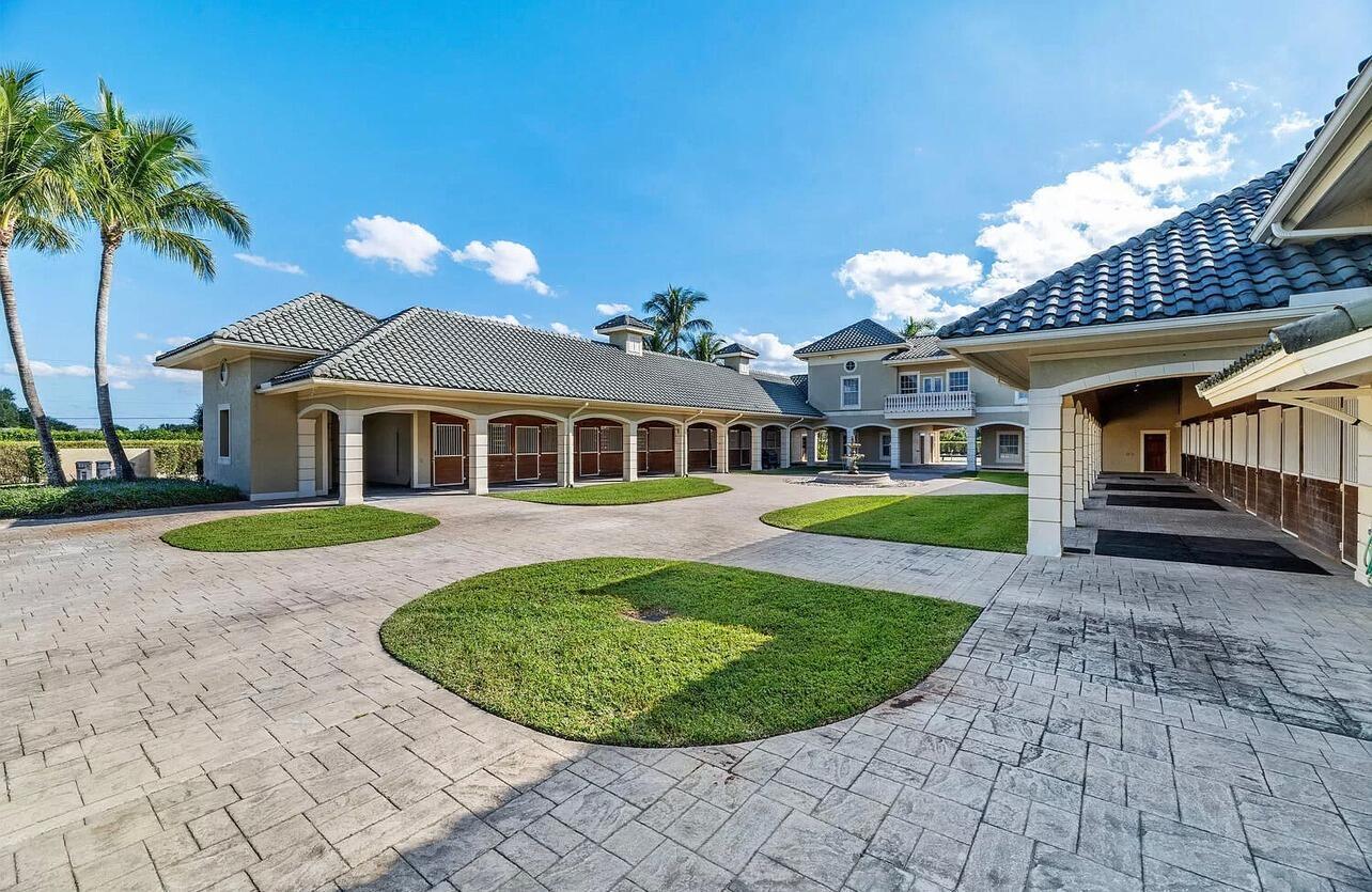 4591 S Road Wellington, FL 33414 - Photo 29 of 42 a view of a house with a swimming pool