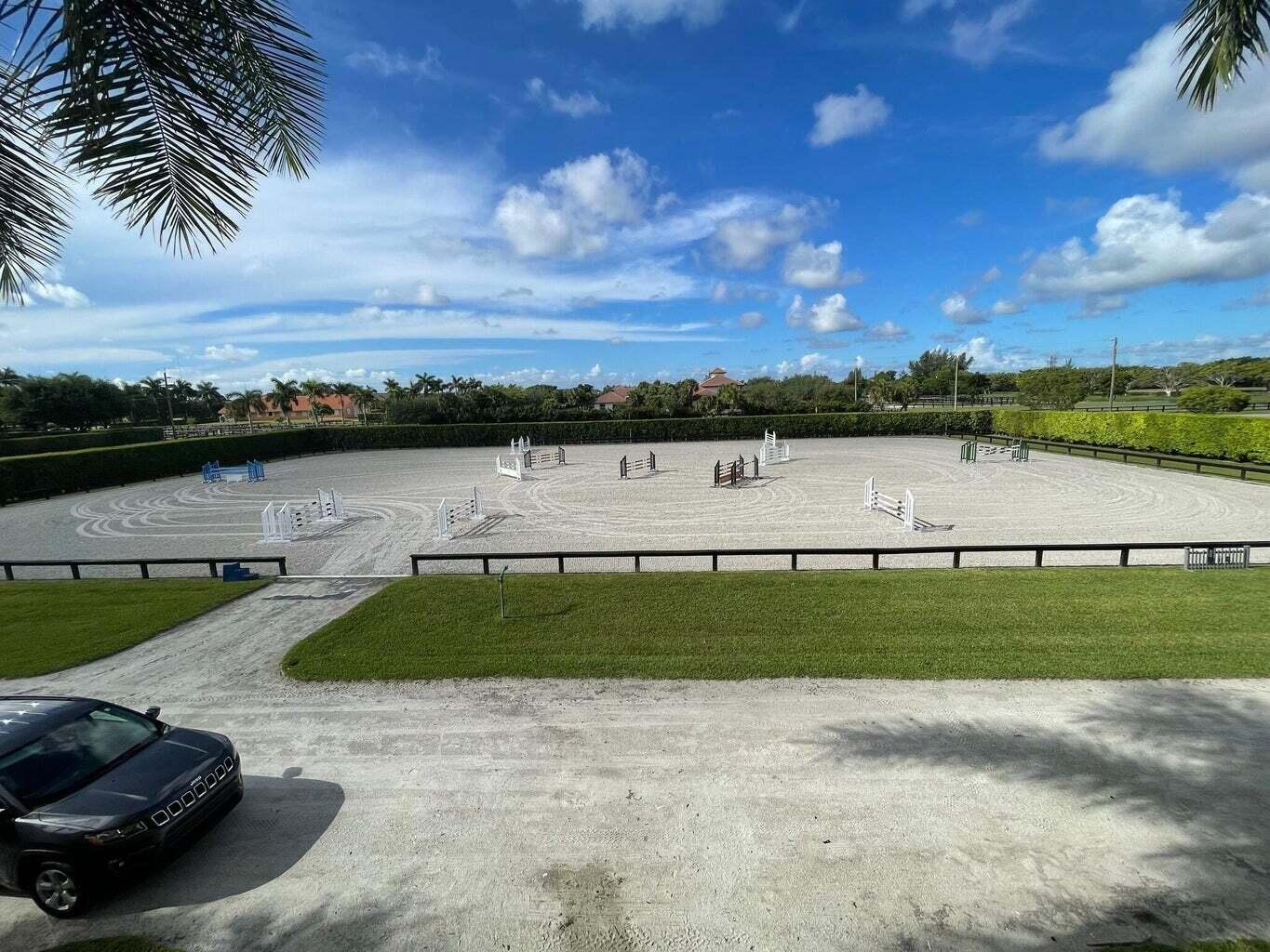4591 S Road Wellington, FL 33414 - Photo 35 of 42 a view of a lake with houses in the back