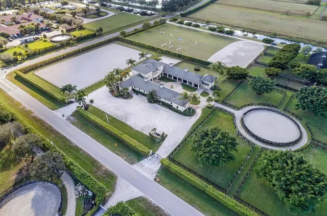 an aerial view of a house yard swimming pool and outdoor seating