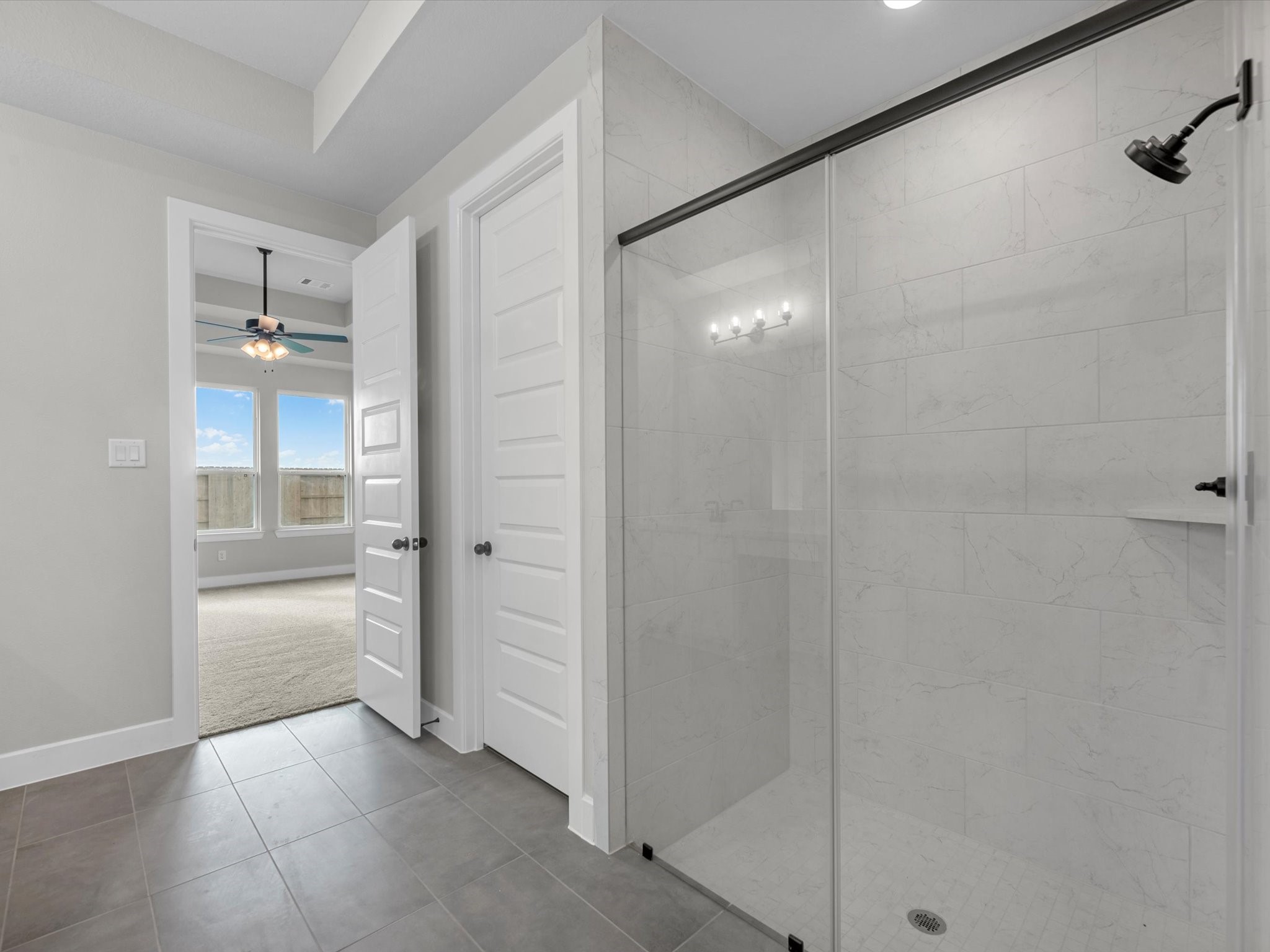 5023 McKinney Rdg Trail Rosenberg, TX 77471 - Photo 13 of 27 a bathroom with a shower and a glass door