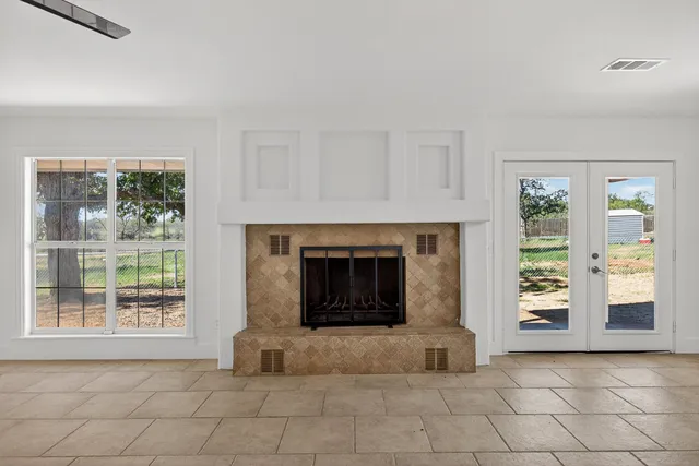 an empty room with furniture and a fireplace