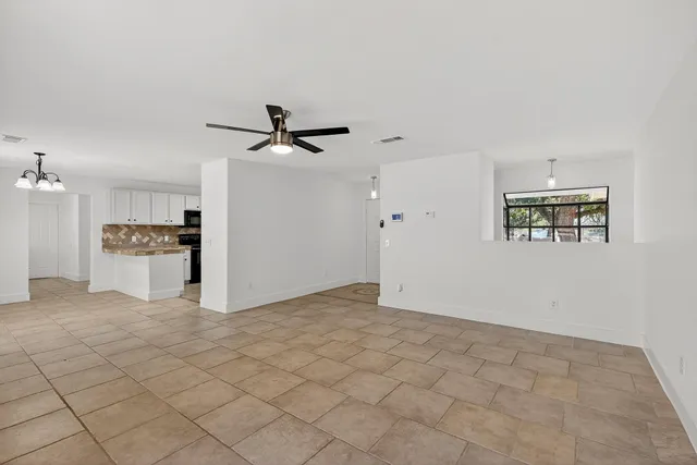 a view of a kitchen with a sink and a refrigerator