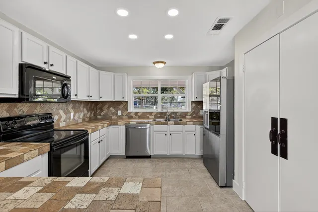 a kitchen with a sink stove and refrigerator