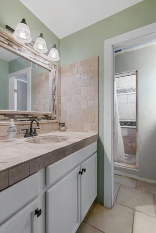 a bathroom with a granite countertop sink a toilet and a mirror