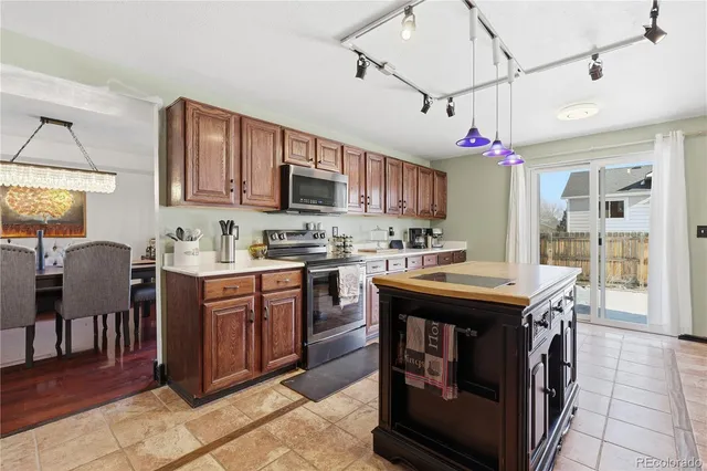 a kitchen with kitchen island granite countertop a sink and a stove