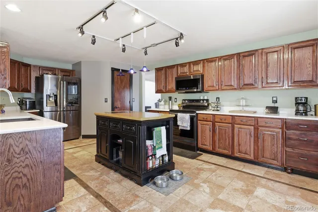a kitchen with stainless steel appliances granite countertop a stove sink and cabinets