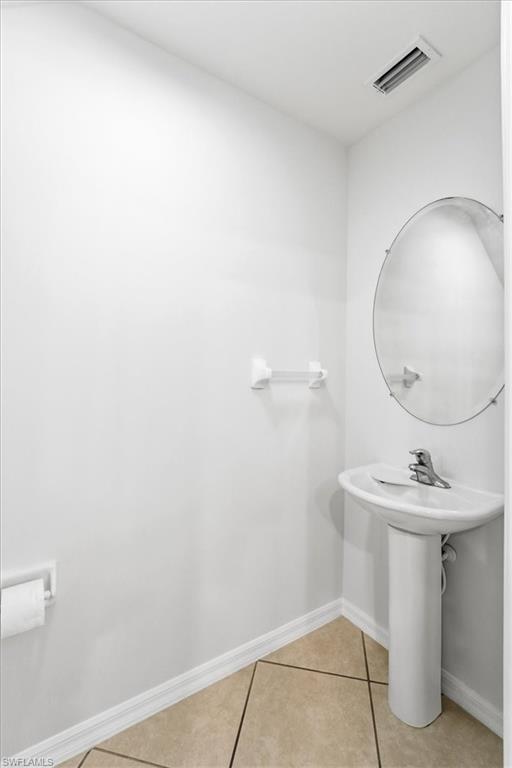 1059 Albany Court, Unit 218 Naples, FL 34105 - Photo 12 of 29 a bathroom with a sink a mirror and vanity