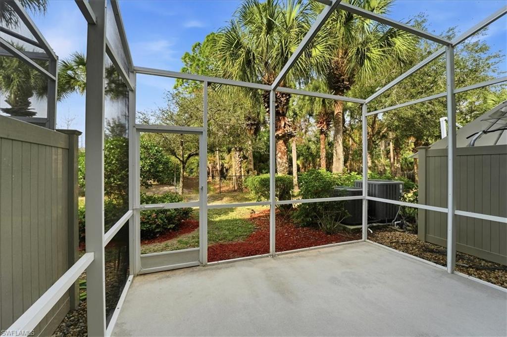 1059 Albany Court, Unit 218 Naples, FL 34105 - Photo 13 of 29 a view of an empty room with wooden floor and windows