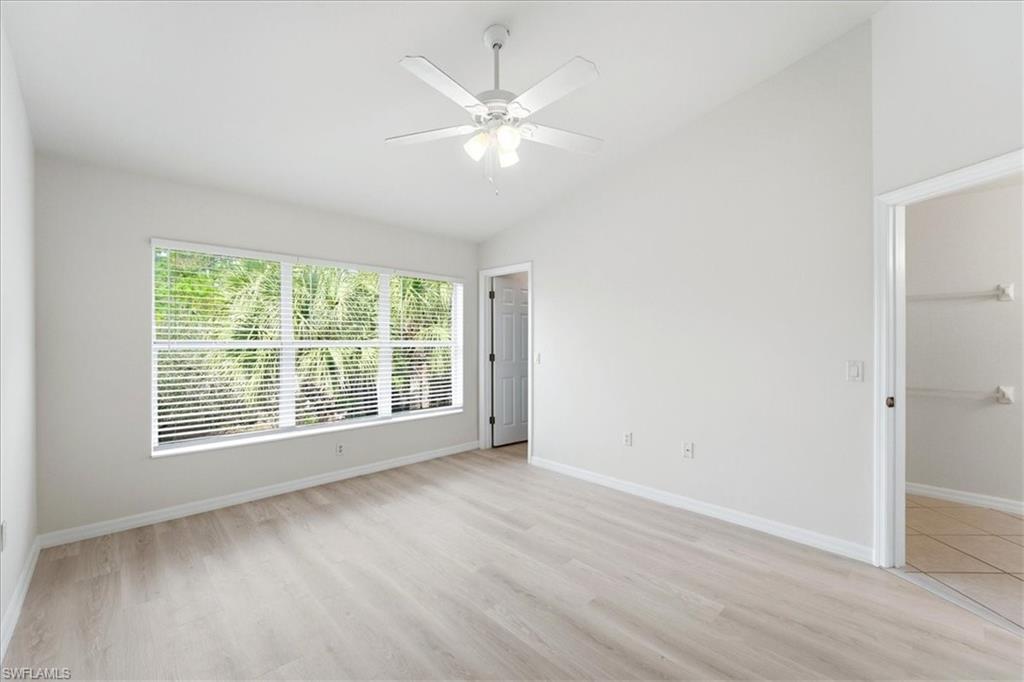 1059 Albany Court, Unit 218 Naples, FL 34105 - Photo 16 of 29 a view of an empty room with wooden floor and a window