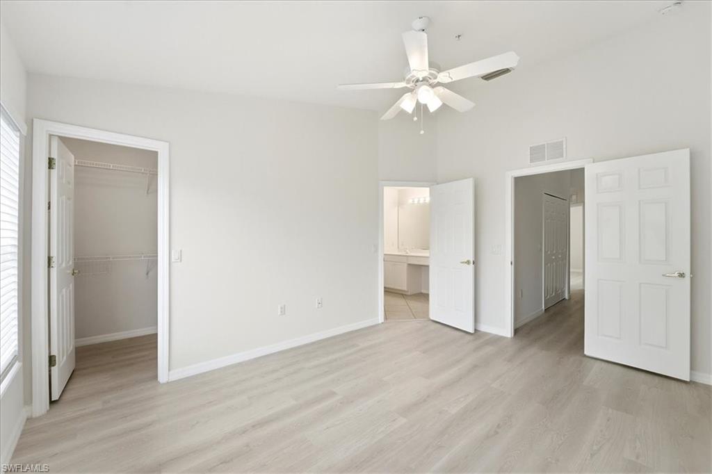 1059 Albany Court, Unit 218 Naples, FL 34105 - Photo 17 of 29 a view of an empty room with wooden floor