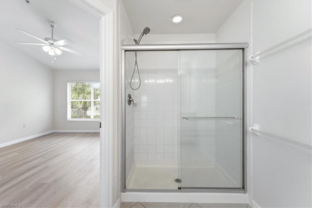 1059 Albany Court, Unit 218 Naples, FL 34105 - Photo 19 of 29 a bathroom with a glass shower door