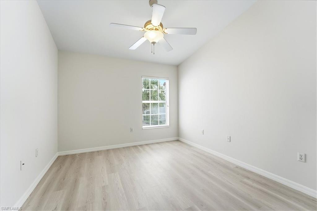 1059 Albany Court, Unit 218 Naples, FL 34105 - Photo 22 of 29 wooden floor in an empty room with a window
