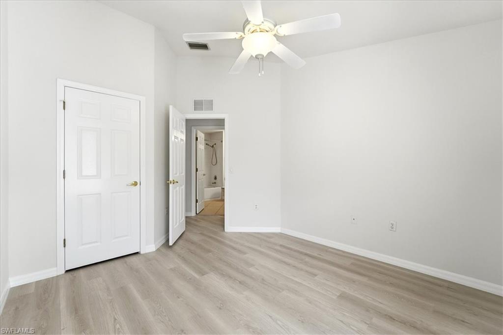 1059 Albany Court, Unit 218 Naples, FL 34105 - Photo 23 of 29 an empty room with a fan and a ceiling fan