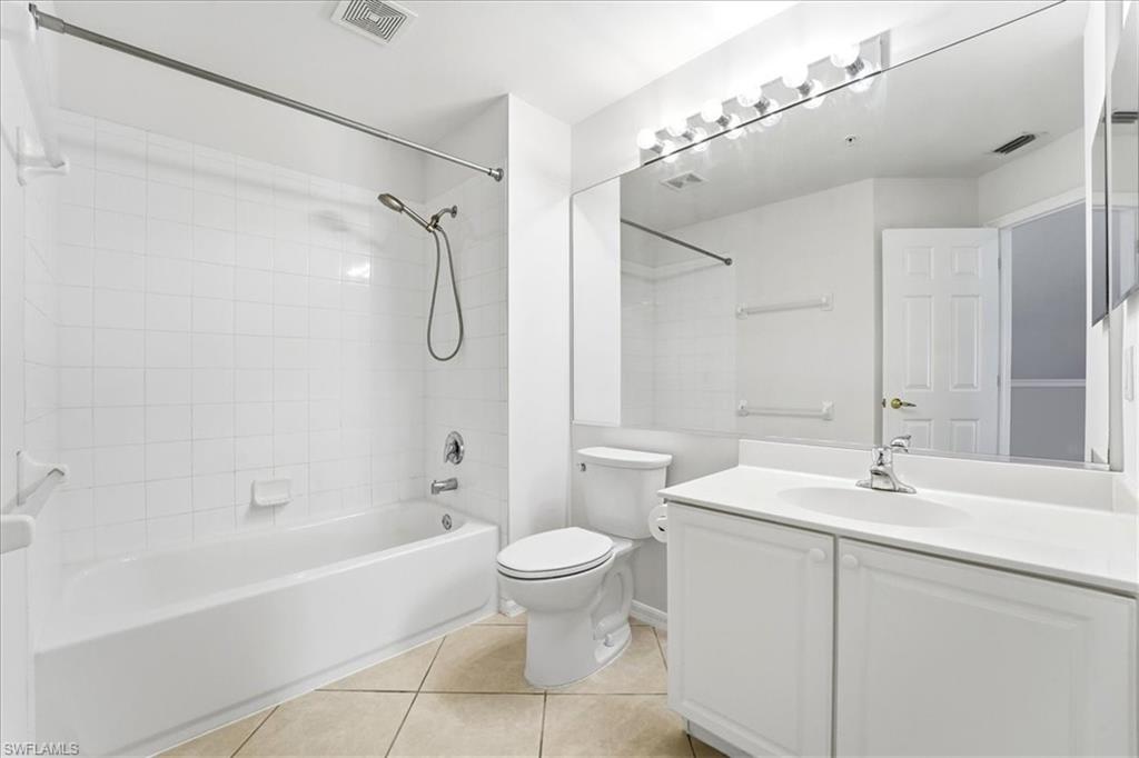 1059 Albany Court, Unit 218 Naples, FL 34105 - Photo 24 of 29 a bathroom with a sink a toilet and a bathtub
