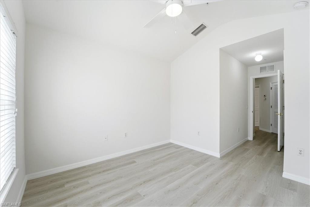 1059 Albany Court, Unit 218 Naples, FL 34105 - Photo 26 of 29 a view of a room with wooden floor and a window