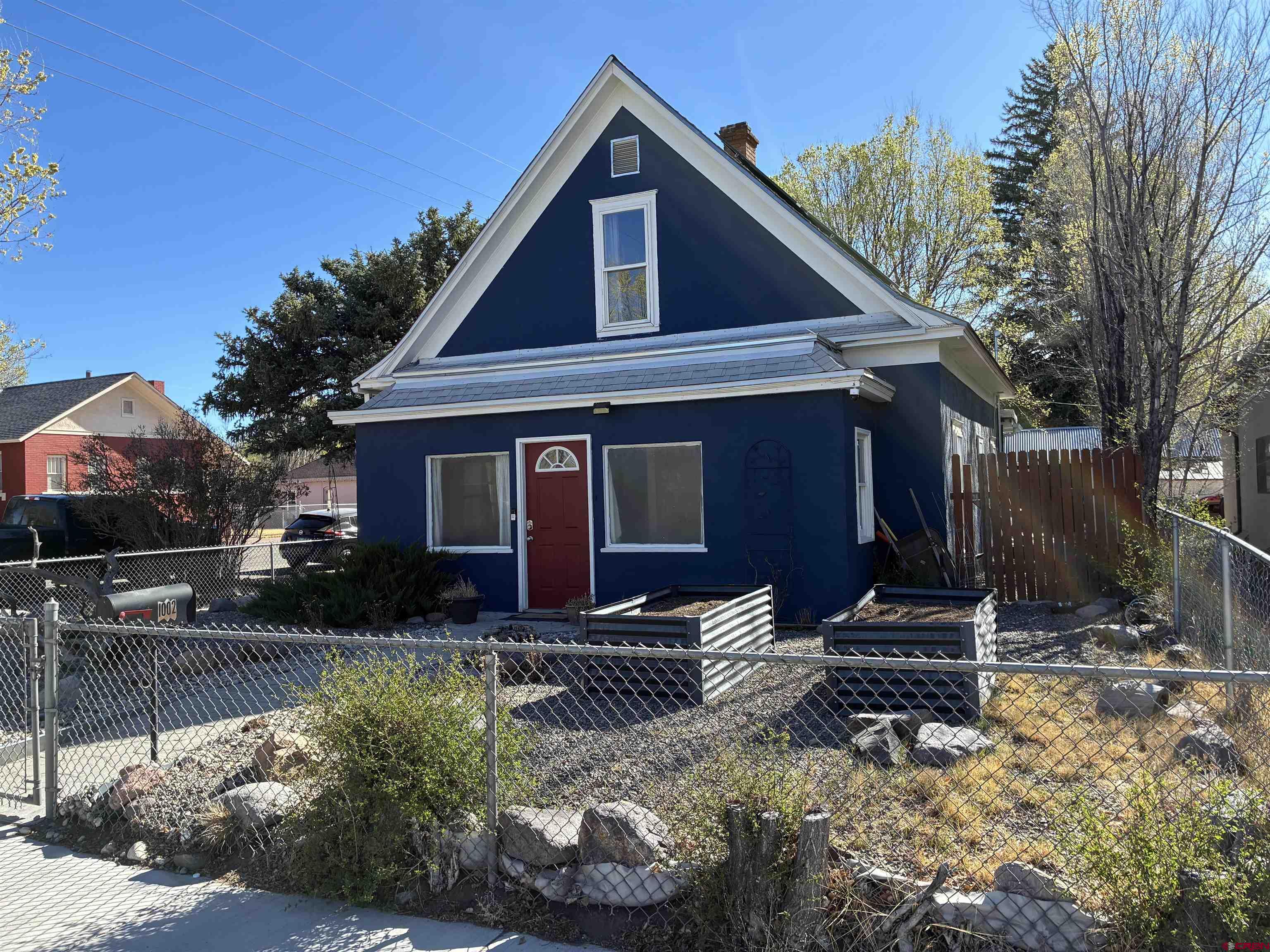1002 State Avenue Alamosa, CO 81101 - Photo 1 of 19 a view of a house with a yard chairs and floor to ceiling window