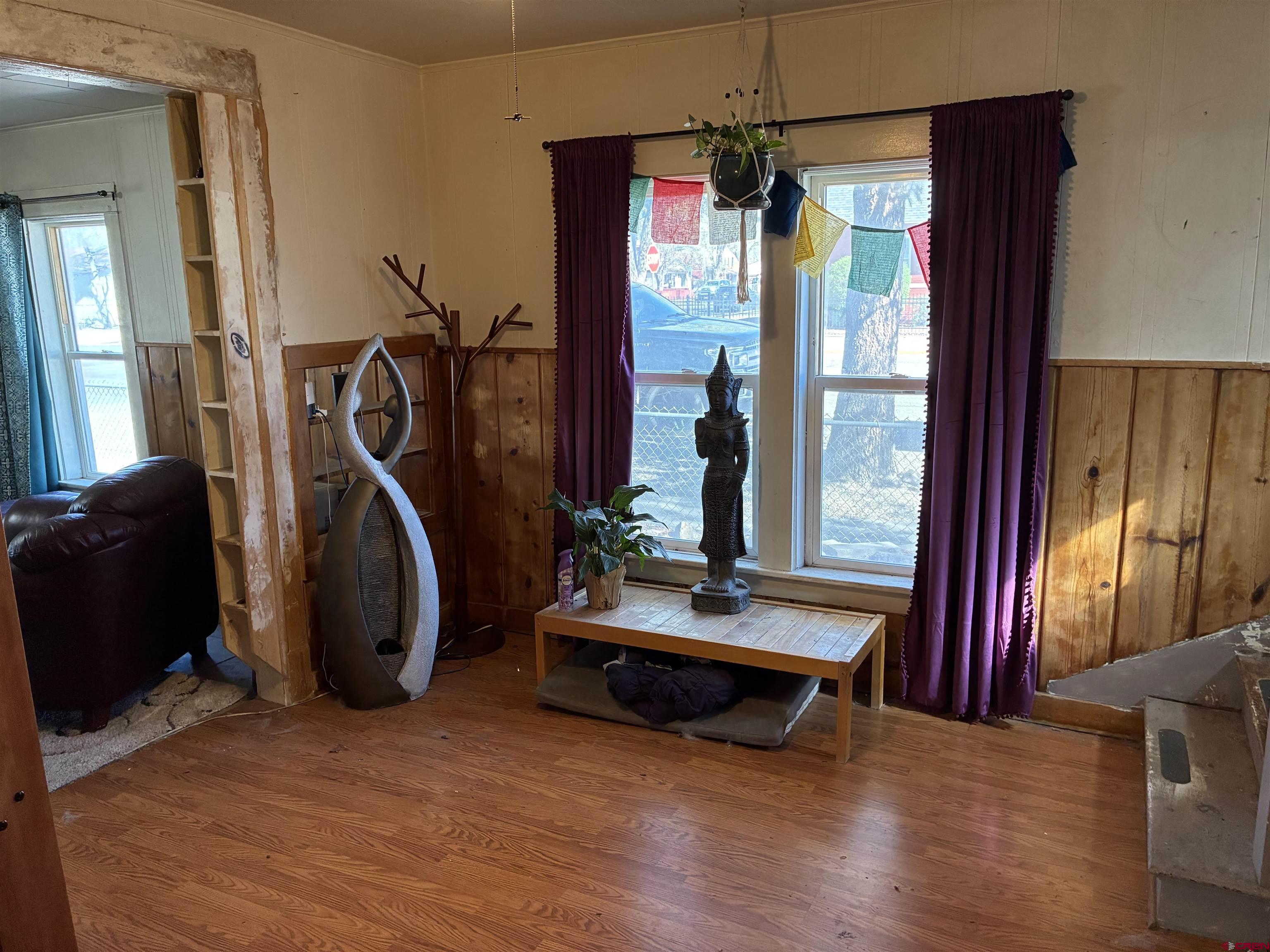 1002 State Avenue Alamosa, CO 81101 - Photo 12 of 19 a living room with furniture a flat screen tv and a window