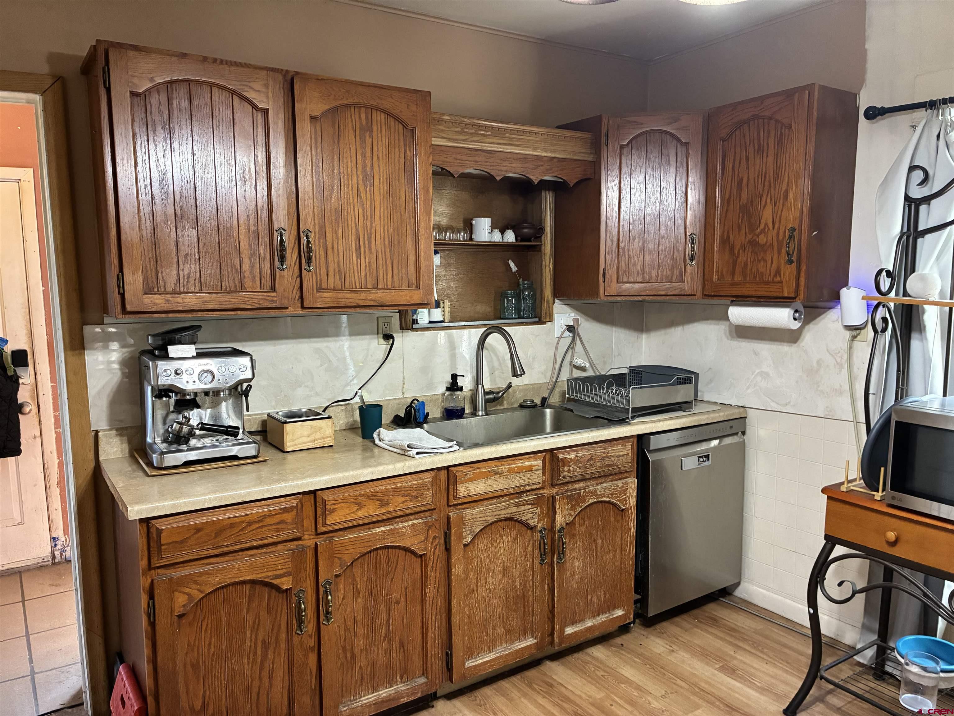 1002 State Avenue Alamosa, CO 81101 - Photo 14 of 19 a kitchen with stainless steel appliances granite countertop a sink a stove and cabinets