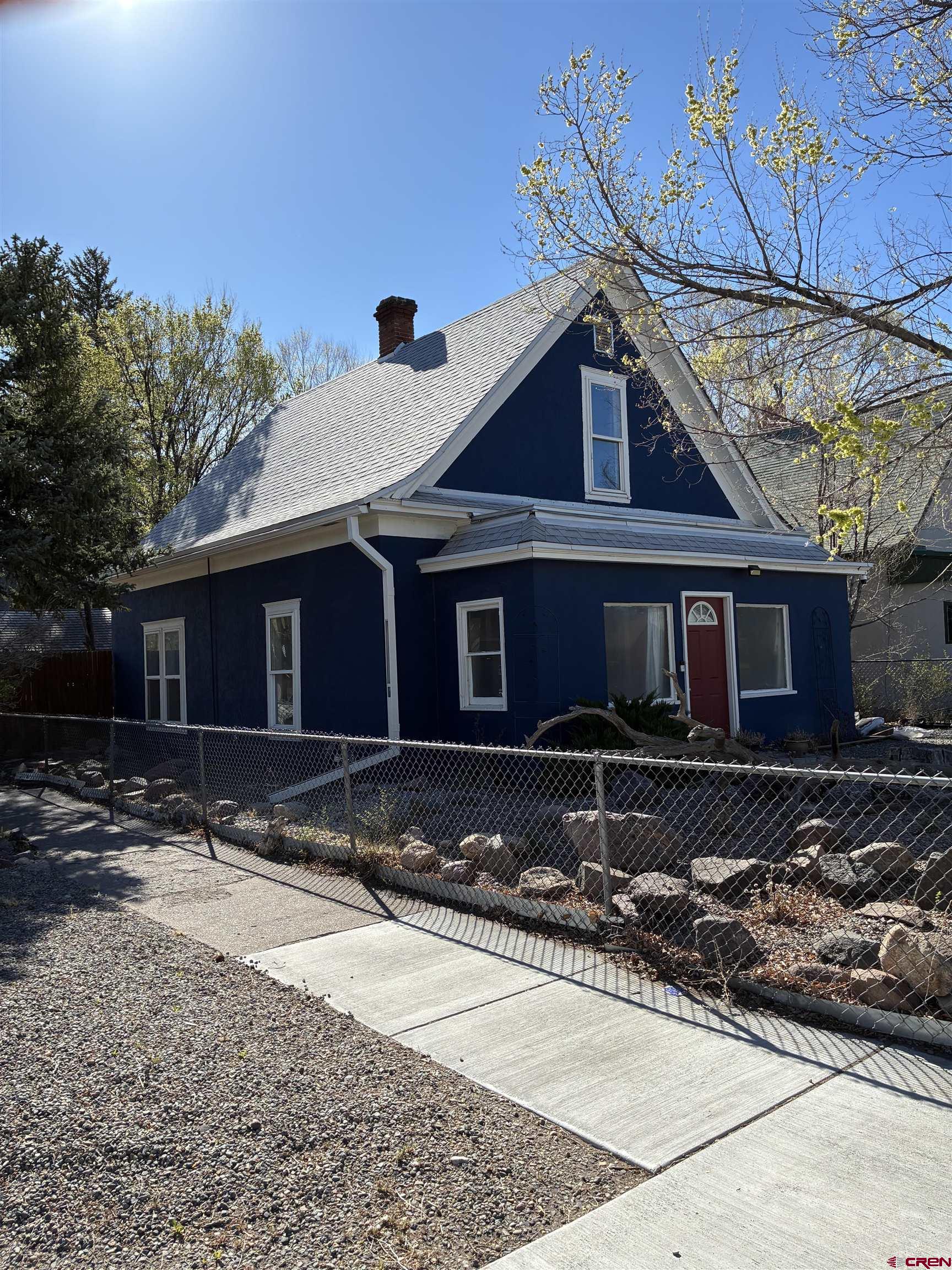 1002 State Avenue Alamosa, CO 81101 - Photo 2 of 19 a front view of a house with a yard