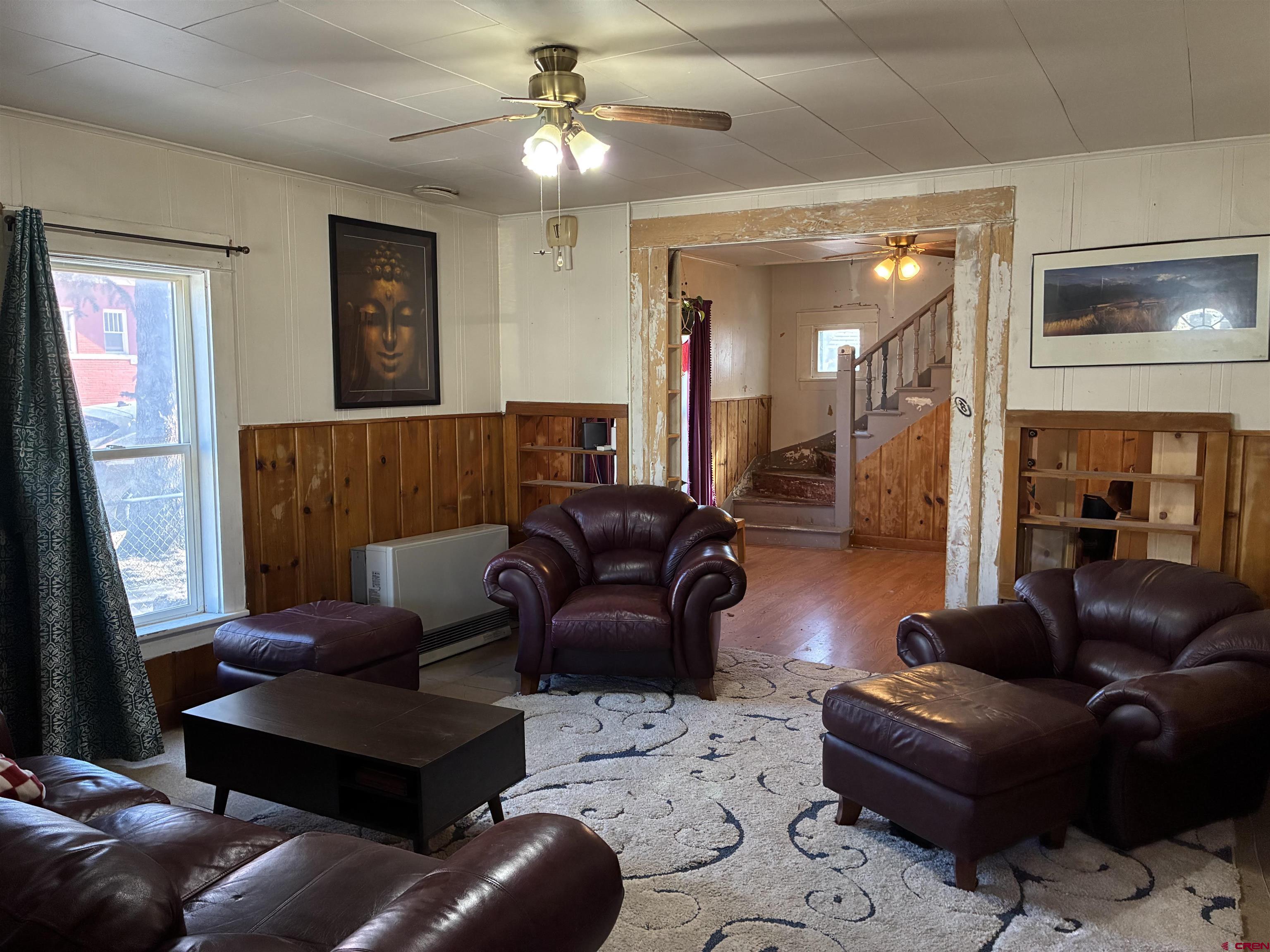 1002 State Avenue Alamosa, CO 81101 - Photo 8 of 19 a living room with furniture and a ceiling fan