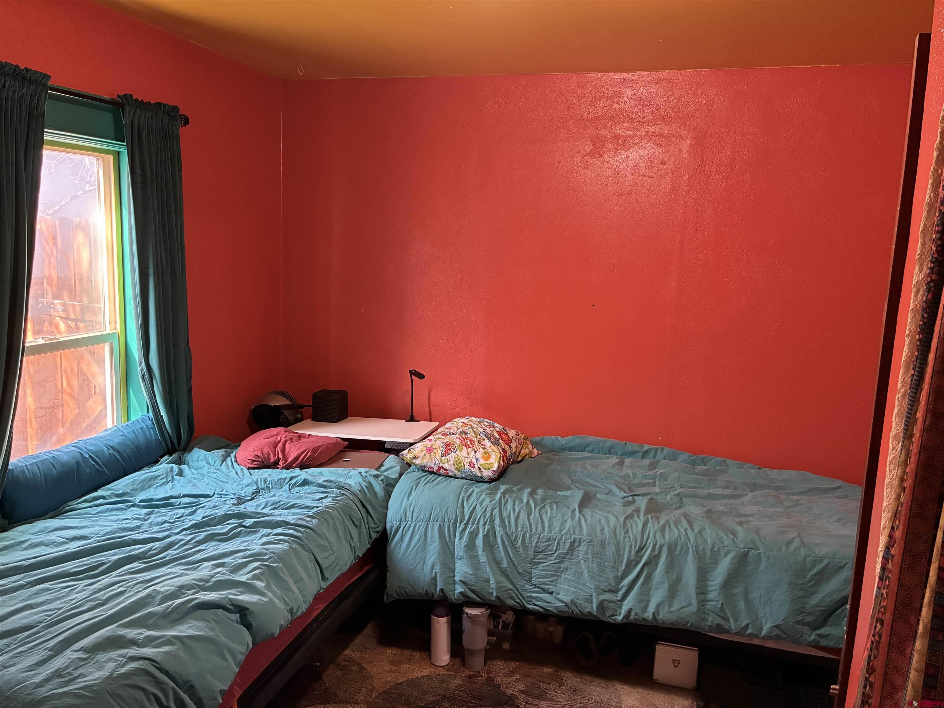 1002 State Avenue Alamosa, CO 81101 - Photo 9 of 19 a bedroom with a bed and a window