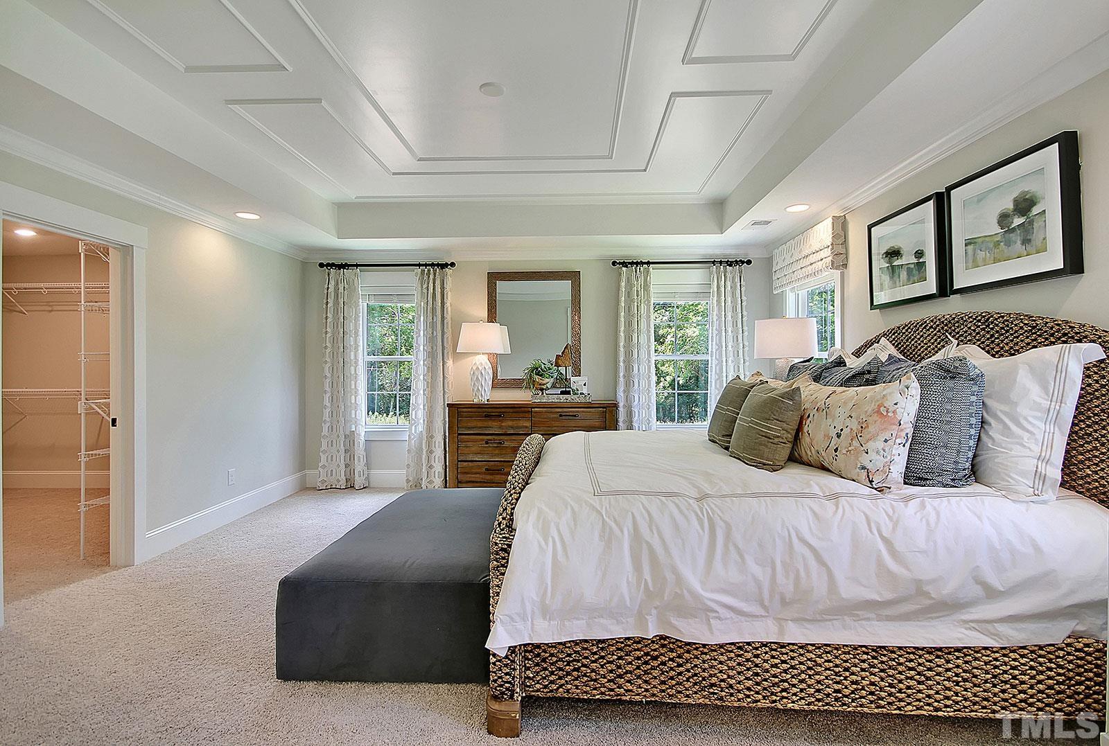 246 Oak Branch Trail Garner, NC 27529 - Photo 16 of 28 a living room with a bed and glass walk in closet