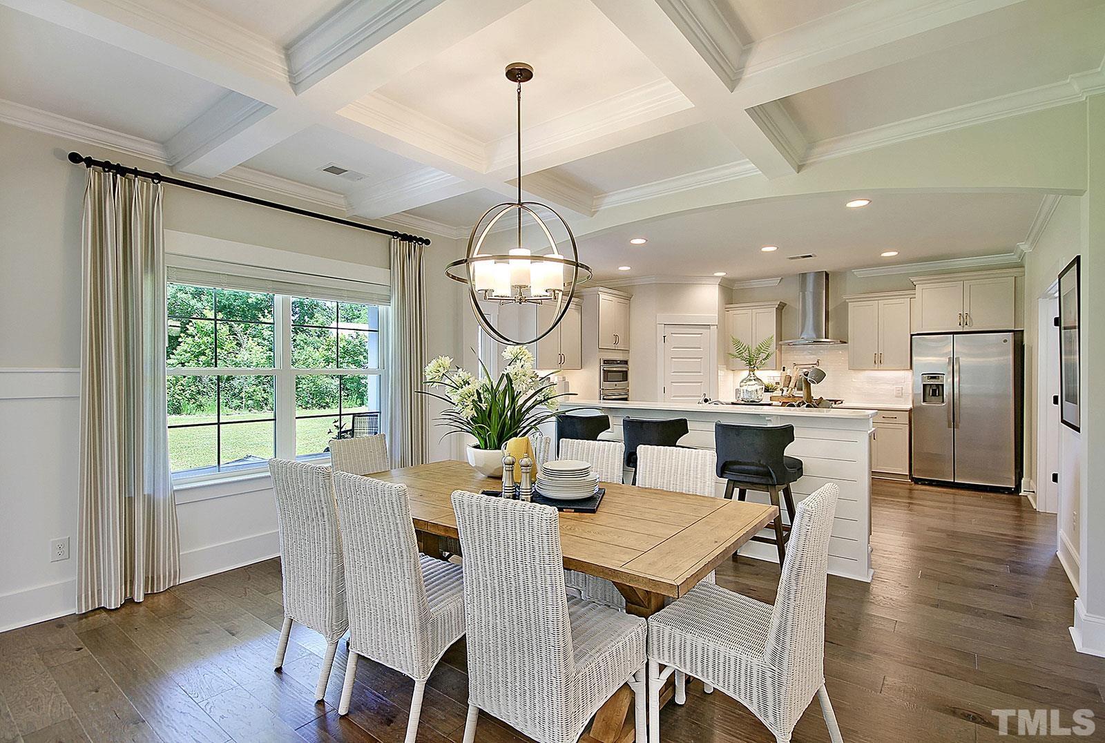 246 Oak Branch Trail Garner, NC 27529 - Photo 7 of 28 a view of a dining room and livingroom with furniture wooden floor a chandelier