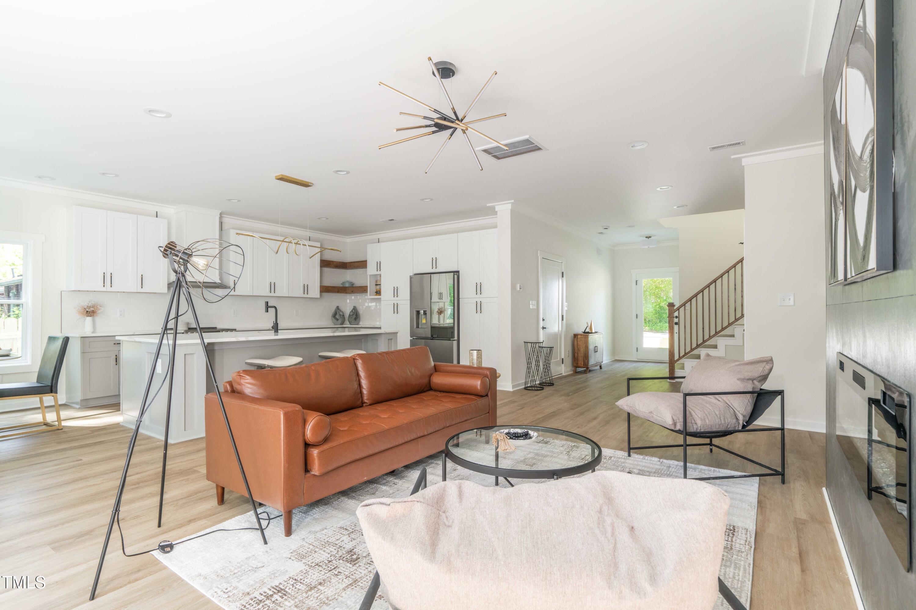 1124 Upchurch Street Raleigh, NC 27610 - Photo 12 of 45 a living room with furniture and a wooden floor