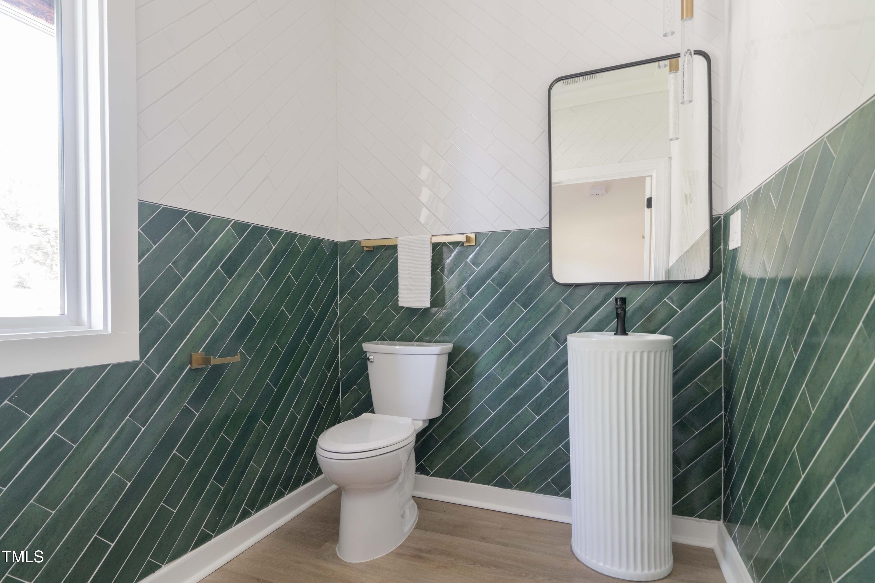 1124 Upchurch Street Raleigh, NC 27610 - Photo 19 of 45 a bathroom with a toilet and a sink