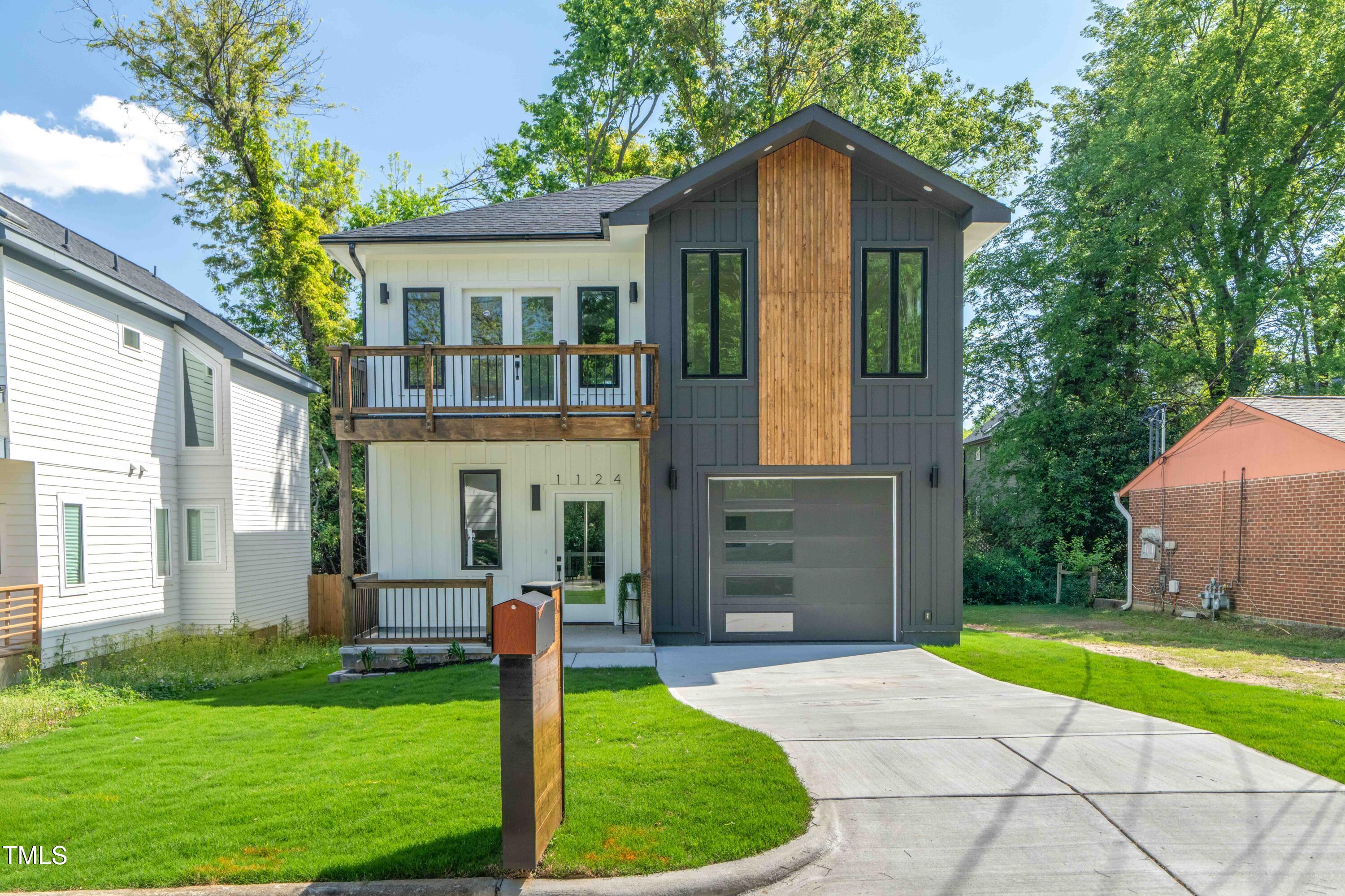1124 Upchurch Street Raleigh, NC 27610 - Photo 2 of 45 a front view of a house with a yard and garage