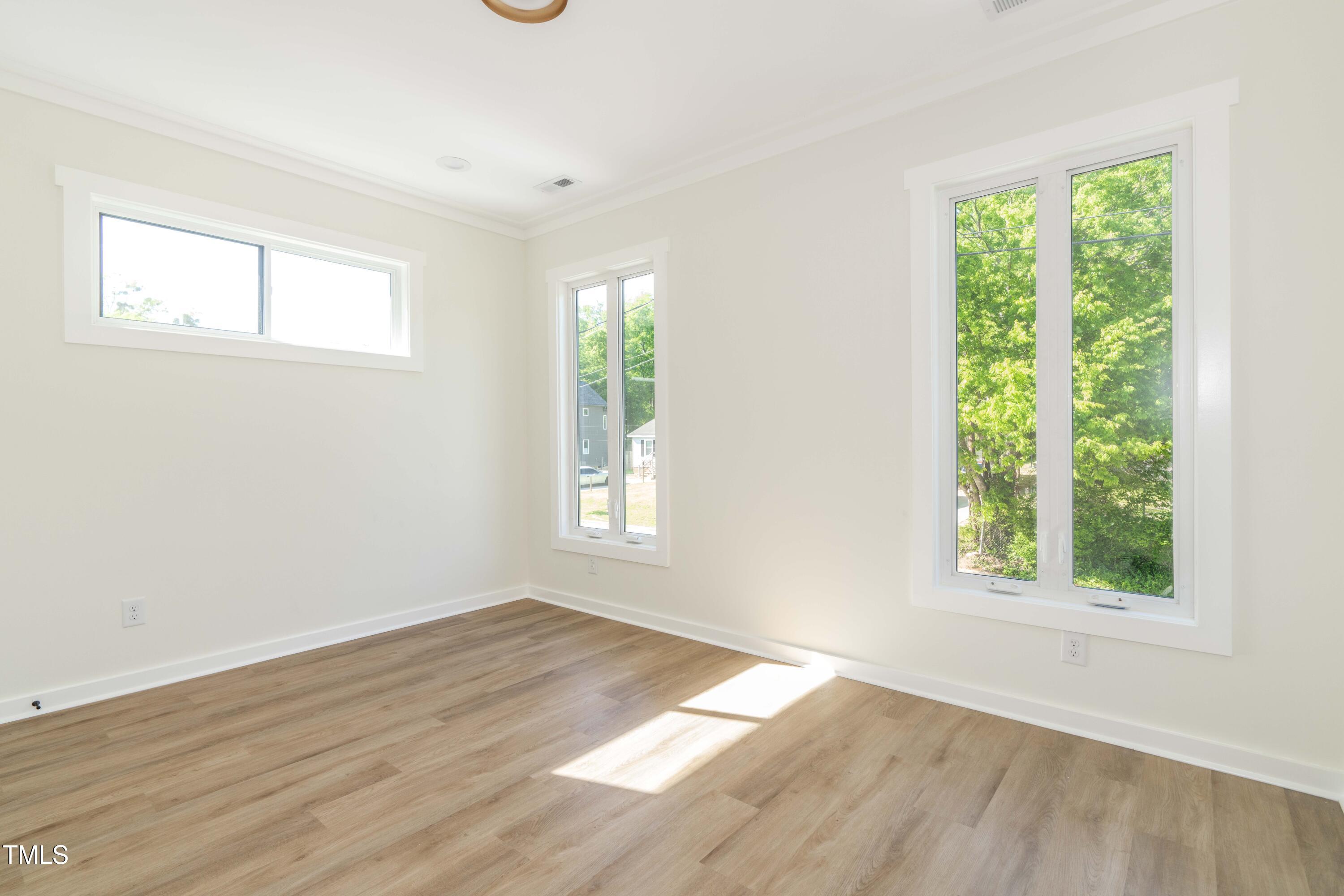 1124 Upchurch Street Raleigh, NC 27610 - Photo 33 of 45 an empty room with wooden floor and windows