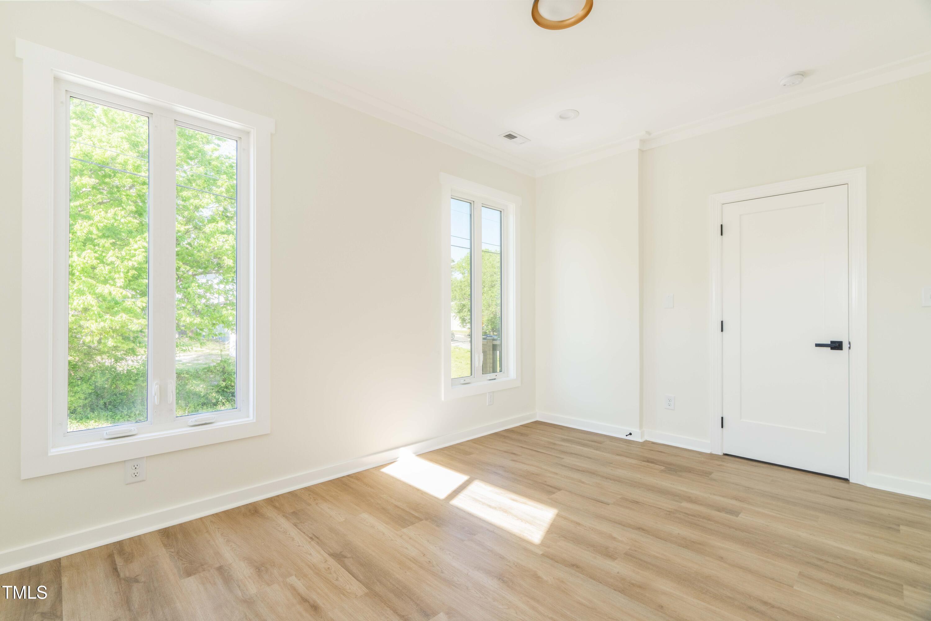 1124 Upchurch Street Raleigh, NC 27610 - Photo 34 of 45 an empty room with wooden floor and windows