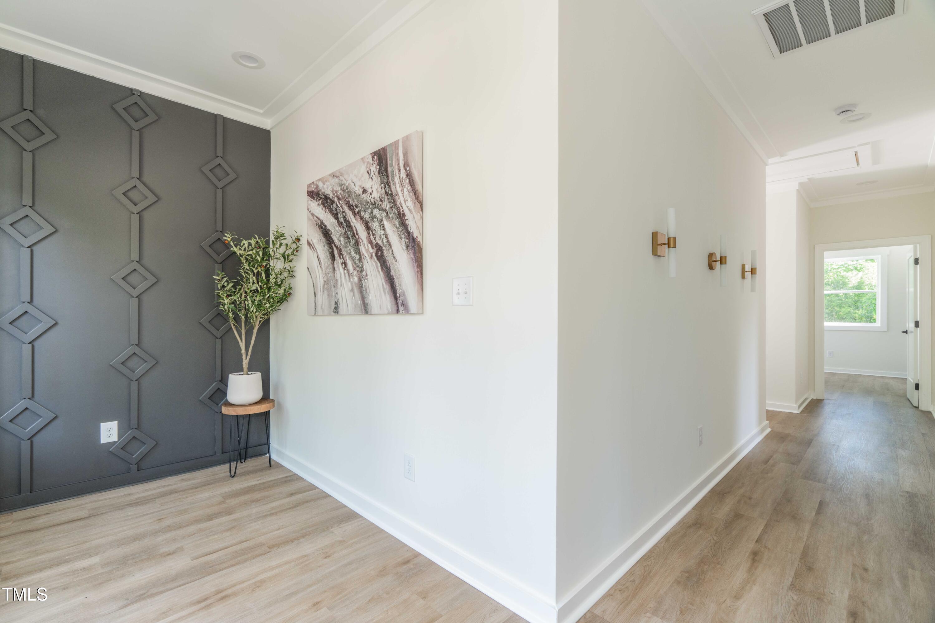 1124 Upchurch Street Raleigh, NC 27610 - Photo 38 of 45 a view of a hallway with wooden floor and stairs