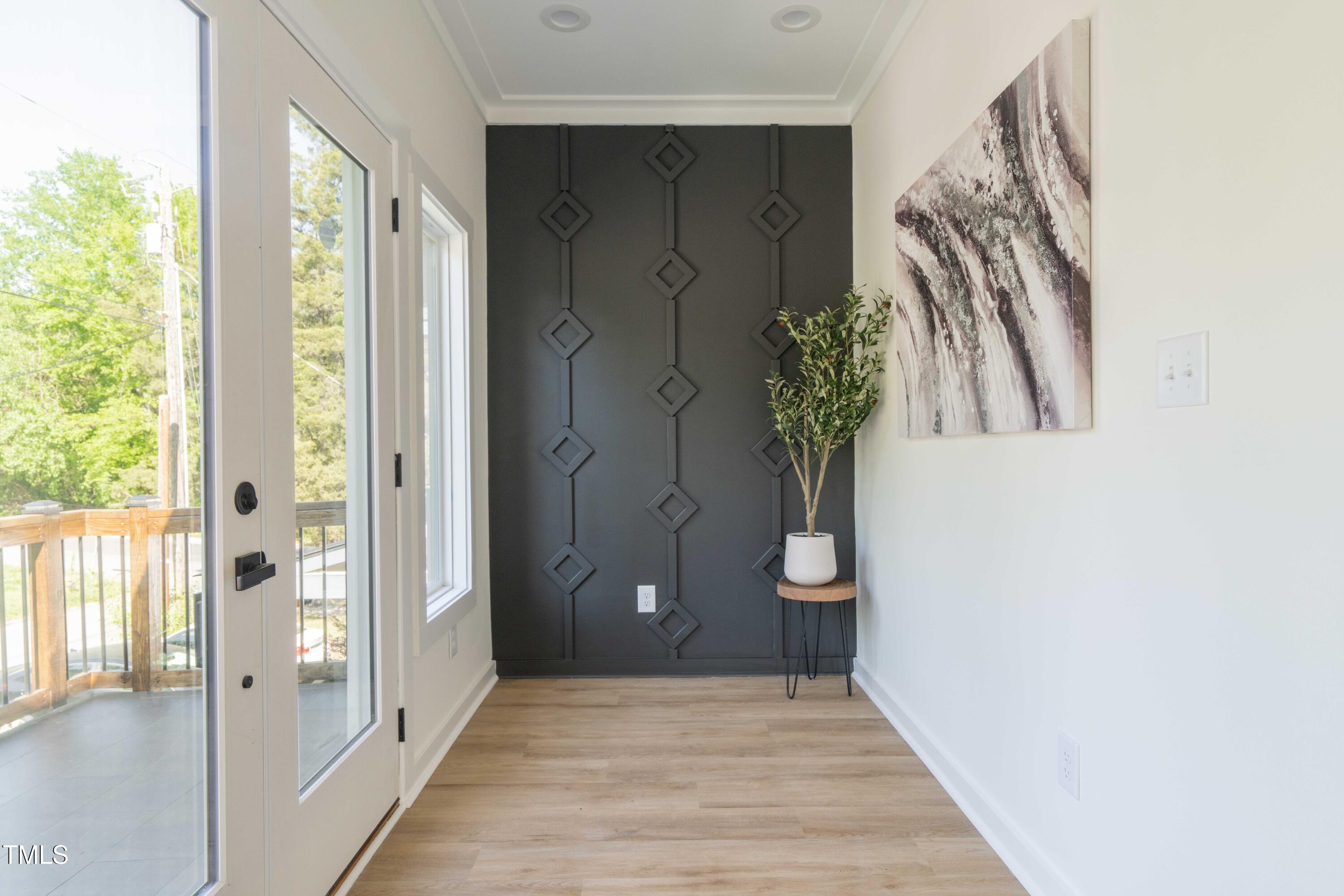 1124 Upchurch Street Raleigh, NC 27610 - Photo 39 of 45 a view of a hallway with wooden floor and a door
