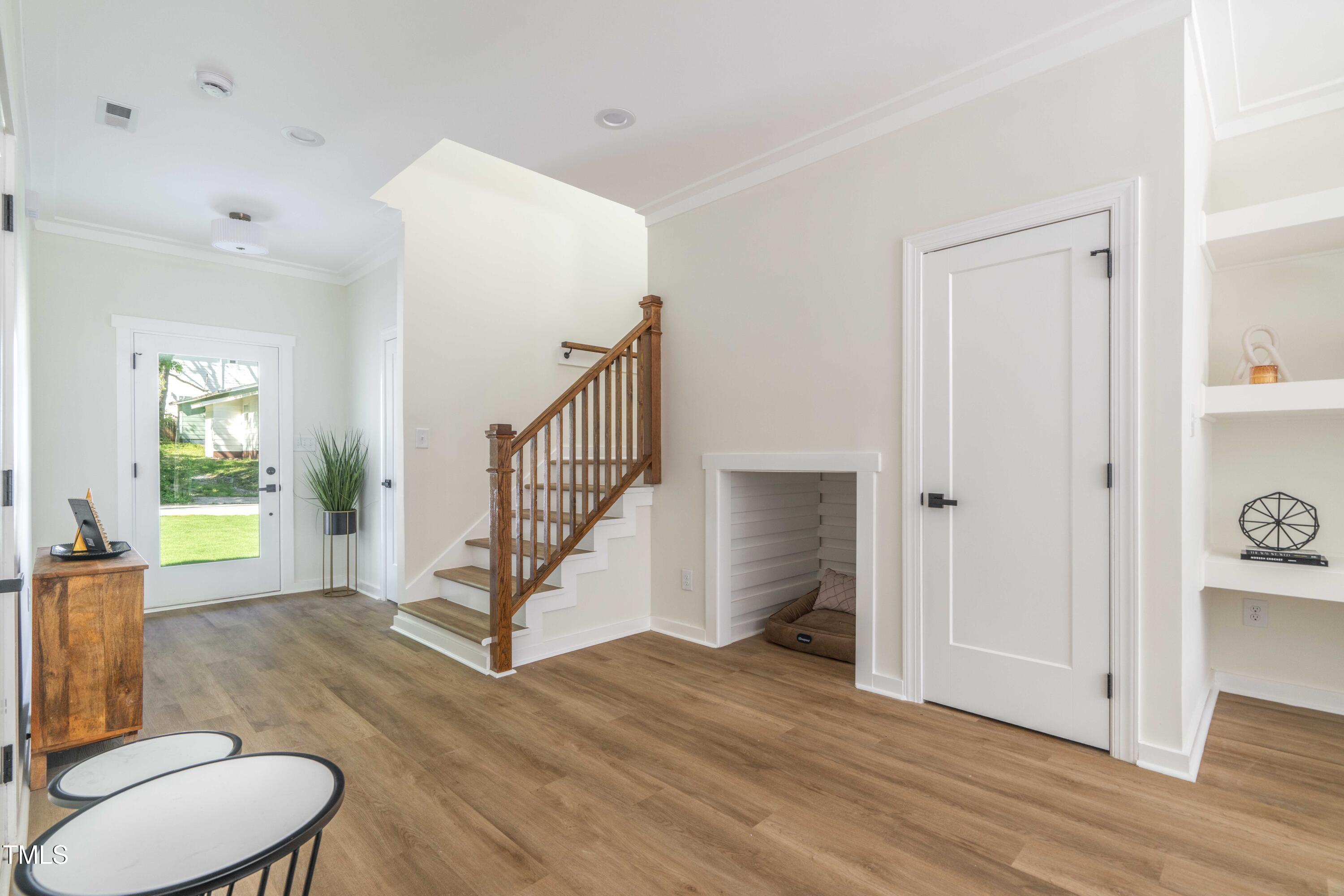 1124 Upchurch Street Raleigh, NC 27610 - Photo 4 of 45 a view of a hallway with bathroom and wooden floor