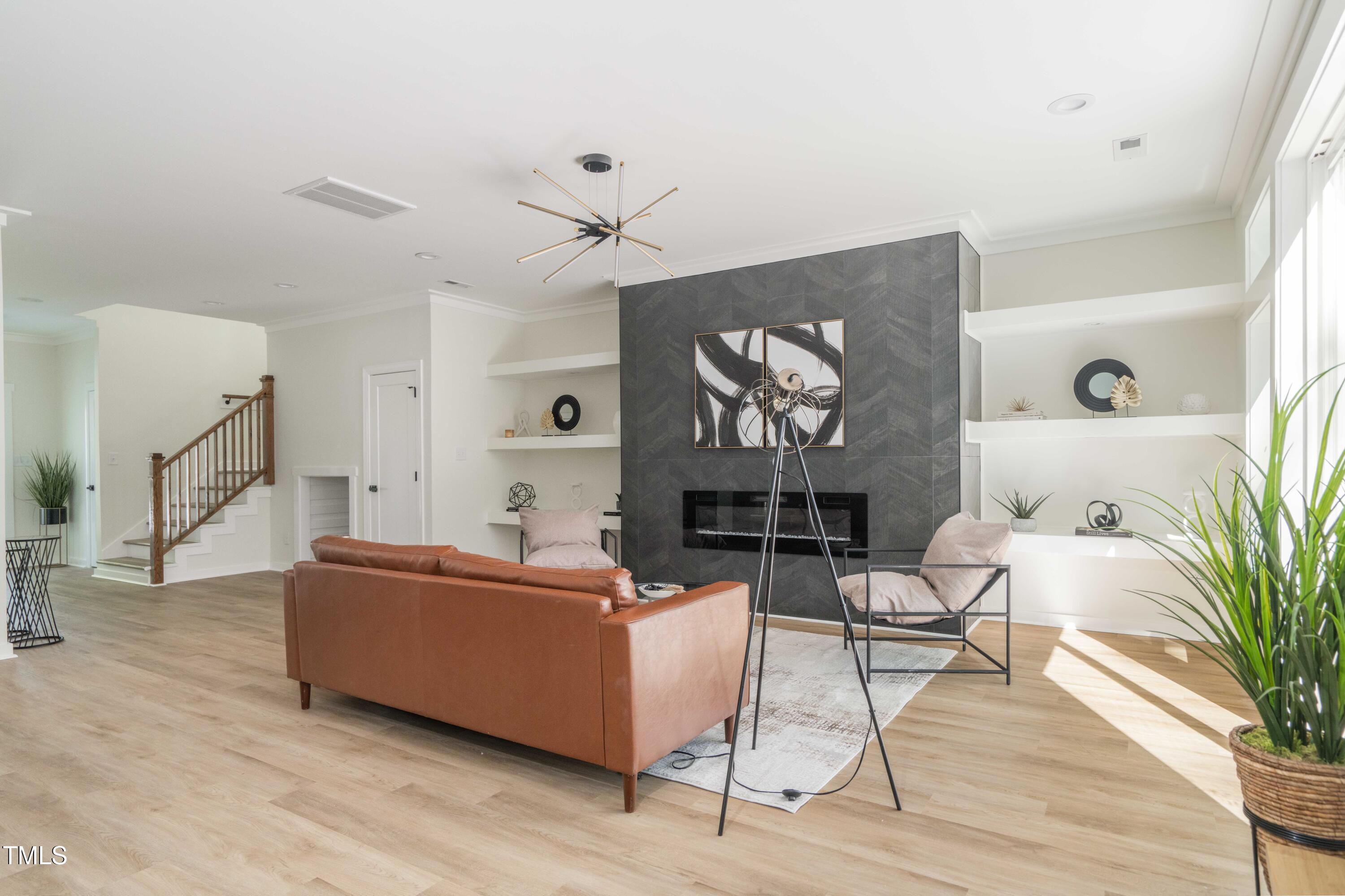 1124 Upchurch Street Raleigh, NC 27610 - Photo 10 of 45 a living room with furniture and a painting on the wall