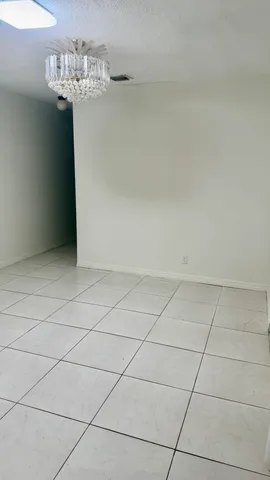 a view of a chandelier in big room and chandelier