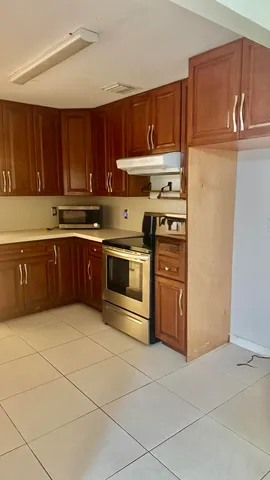a kitchen with stainless steel appliances granite countertop a stove and a refrigerator