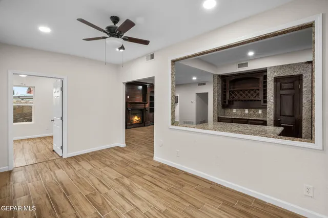 a view of an empty room with wooden floor