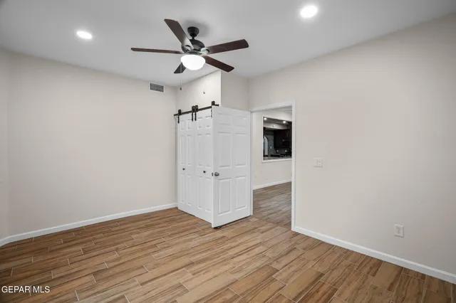 a view of a hallway with wooden floor