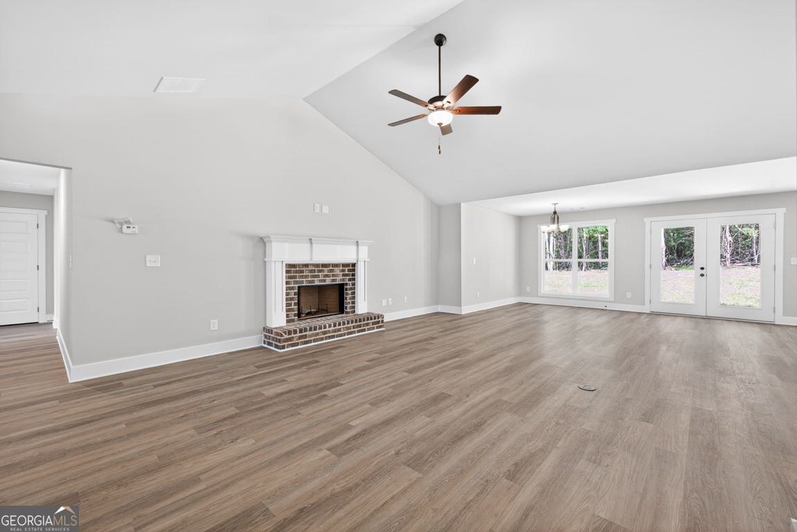 206 Airport Road, Unit 11 Canon, GA 30520 - Photo 7 of 34 a view of an empty room with a window and wooden floor