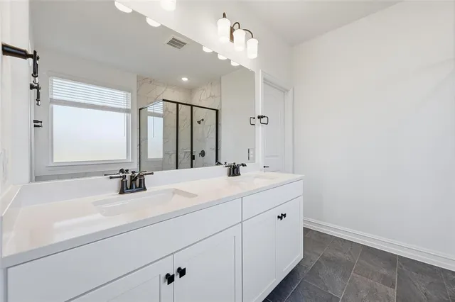 a bathroom with a double vanity sink mirror and double