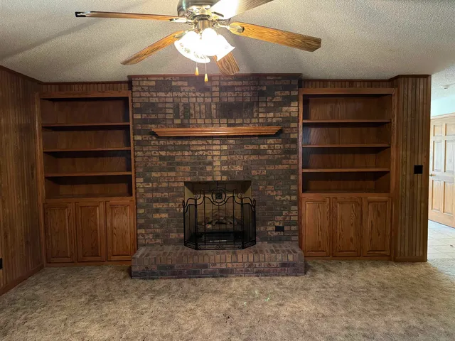 a room with fireplace and cabinets