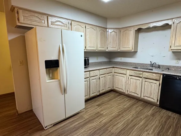 a white refrigerator freezer sitting inside of a kitchen